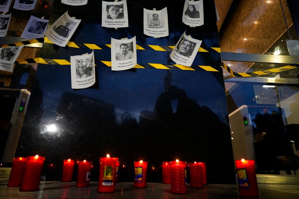 Photos of slain journalists are up on a wall during a vigil to protest the murder of journalist Fredid Roman, outside Mexico's Attorney General's office in Mexico City, Wednesday, Aug. 24, 2022. Roman was the 15th media worker killed so far this year in Mexico, where it is now considered the most dangerous country for reporters outside a war zone. (AP Photo/Eduardo Verdugo)