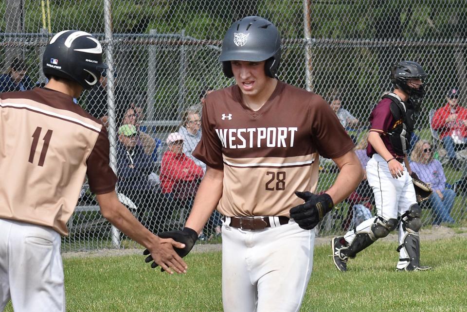 Westport's Max Morotti is congratulated by teammate Luke Finglas after crossing home plate.