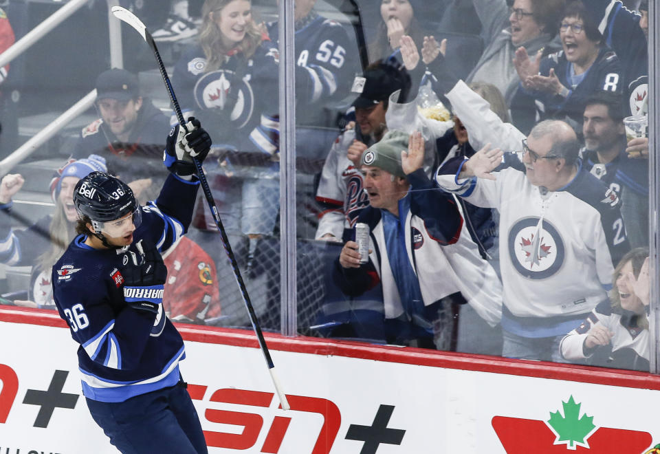 Winnipeg Jets' Morgan Barron (36) celebrates his goal against Chicago Blackhawks goaltender Arvid Soderblom (40) during the second period of an NHL game in Winnipeg, Manitoba, Saturday, Dec. 2, 2023. (John Woods/The Canadian Press via AP)