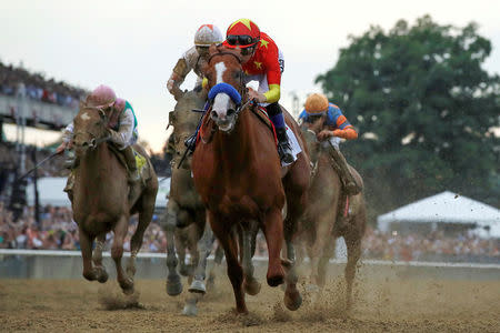 FILE PHOTO: Justify with jockey Mike Smith aboard wins the 150th running of the Belmont Stakes, the third leg of the Triple Crown of Thoroughbred Racing at Belmont Park in Elmont, New York, U.S., June 9, 2018. REUTERS/Mike Segar