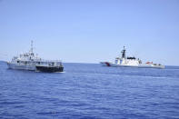 In this May 14, 2019, photo, photo provided by the Philippine Coast Guard, U.S. Coast Guard Cutter Bertholf, right, and Philippine counterpart BRP Batangas conduct joint search and rescue and capability-building exercises off the South China Sea west of the Philippines. Captain John Driscoll, commanding officer of the U.S. Coast Guard National Security Cutter Bertholf (WMSL 750), told reporters Wednesday, May 15, 2019, two Chinese Coast Guard ships were spotted off the South China Sea while they were conducting the joint exercise with Philippine Coast Guard. (Philippine Coast Guard Via AP)