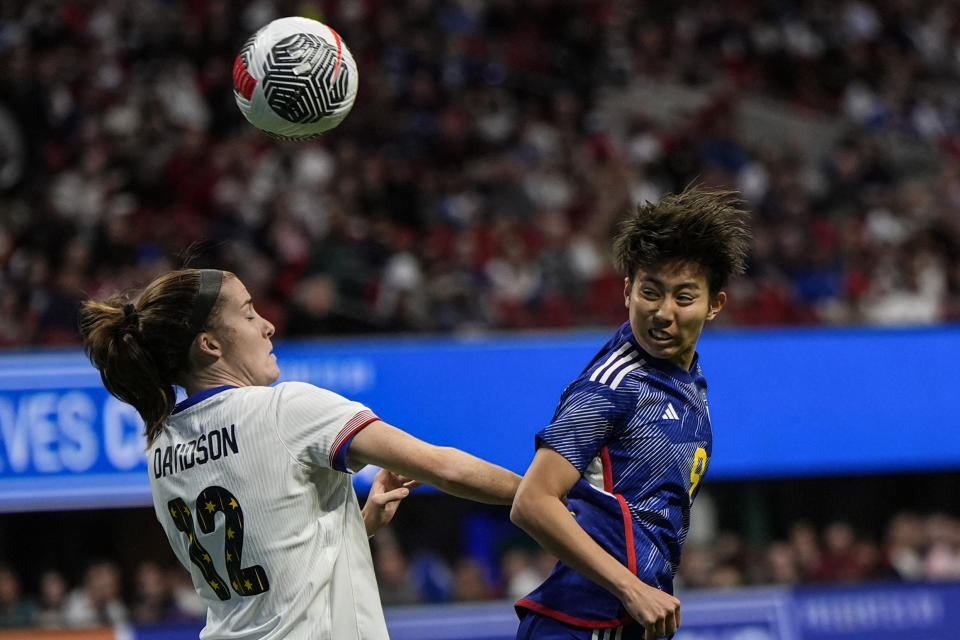 Japan's Riko Ueki (9) heads the ball as United States' Tierna Davidson (12) defends in the first half of the SheBelieves Cup women’s soccer tournament, Saturday, April 6, 2024, in Atlanta. (AP Photo/Mike Stewart)