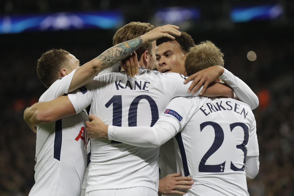 Tottenham’s Dele Alli, rear, and Tottenham’s Harry Kane hug teammate Christian Eriksen (AP Photo/Matt Dunham)