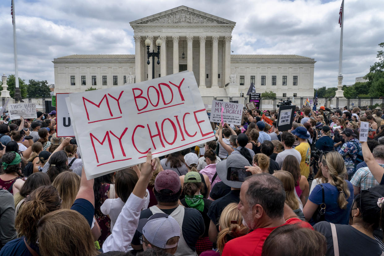 Abortion-rights protesters, including one holding a poster sayings, My Body, My Choice, outside the Supreme Court.