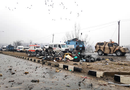 Indian soldiers examine the debris after an explosion in Lethpora in south Kashmir's Pulwama district February 14, 2019. REUTERS/Younis Khaliq/Files