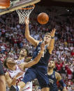 Penn State forward John Harrar (21) reaches for the ball while battling for a rebound with Indiana forward Race Thompson (25) during the second half of an NCAA college basketball game, Wednesday, Jan. 26, 2022, in Bloomington, Ind. (AP Photo/Doug McSchooler)
