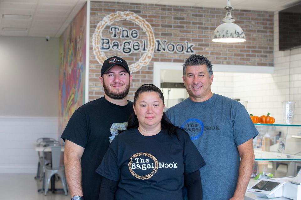 The Bagel Nook owners Alex Berkowitz (left) and David Berkowitz (right) pose with Limor Shekhter inside the new Bagel Nook location in Freehold Township.