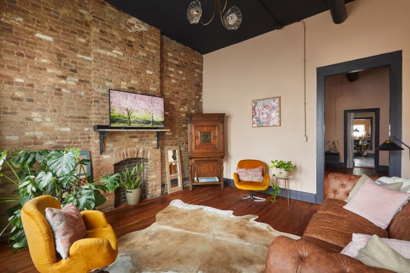 Brick walls and vintage furniture in newly renovated living room.