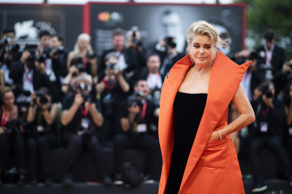 FILE - In this Aug. 28, 2019 file photo, French actress Catherine Deneuve poses for photographers upon arrival at the premiere of the film 'The Truth' and the opening gala at the 76th edition of the Venice Film Festival, Venice, Italy. Denueve's family said in a statement released Wednesday Nov. 6, 2019, that the 76-year-old actress suffered a "very limited and therefore reversible" stroke. (Photo by Arthur Mola/Invision/AP, File)