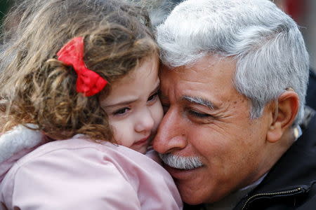 REFILE - CORRECTING CITY Hagop Manushian, a Syrian refugee who arrived earlier in the morning is reunited with his granddaughter Rita at the Armenian Community Centre of Toronto in Toronto, December 11, 2015. REUTERS/Mark Blinch