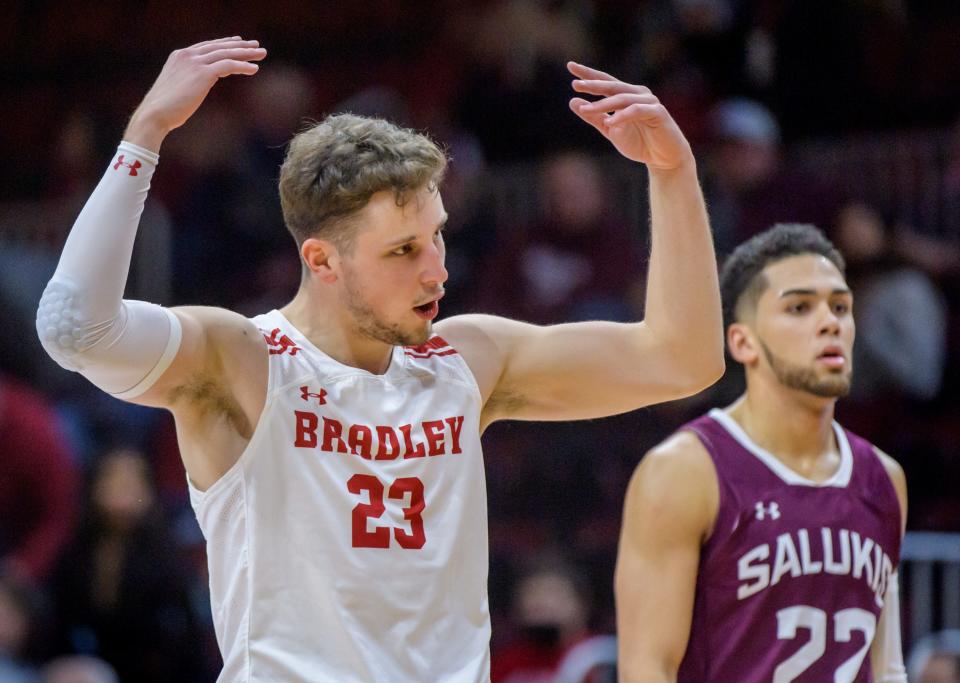 Bradley's Ville Tahvanainen throws his arms up to hype the crowd as time winds down on the Braves' 70-62 win over Southern Illinois on Saturday, Jan. 22, 2022 at Carver Arena.