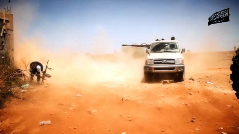 An image from a video made available on October 9, 2014, by the media outlet of the Islamist Ansar al-Sharia group, al-Raya Media Foundation, allegedly shows Ansar al-Sharia militants during a battle in Benghazi