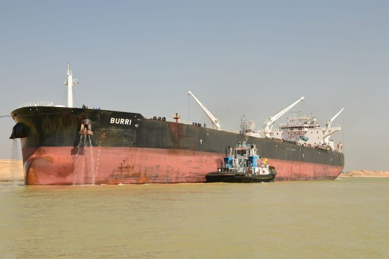 A tugboat works to refloat the Oil Products Tanker BURRI after it collided with LNG Tanker BW Lesmes in Suez Canal