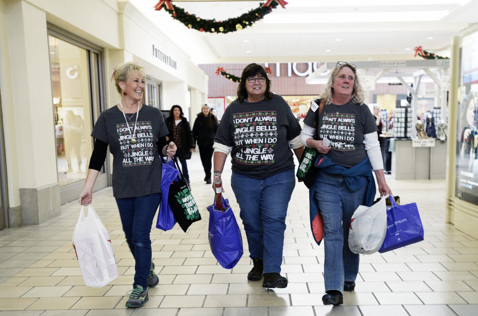 Michelle Bartlett of Westbrook, Karen Thompson of Naples and Ginger Throgmorton shop in the Maine Mall wearing matching shirts Friday, November 23, 2018. (Staff photo by Shawn Patrick Ouellette/Portland Portland Press Herald via Getty Images)