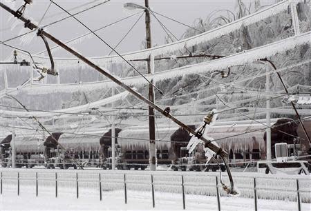 Ice covered broken power lines are seen in Postojna railway station February 4, 2014. REUTERS/Srdjan Zivulovic