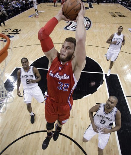 Los Angeles Clippers' Blake Griffin (32) soars to the basket past San Antonio defenders Tony Parker (9), of France, Kawhi Leonard (2) and Boris Diaw (33), of France, during the first quarter of Game 1 of an NBA basketball Western Conference semifinal playoff series, Tuesday, May 15, 2012, in San Antonio. (AP Photo/Eric Gay)