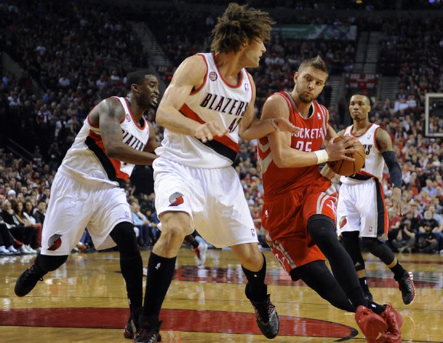 Houston Rockets' Chandler Parsons (25) drives to the basket against Portland Trail Blazers' Robin Lopez (42) during the first half of game six of an NBA basketball first-round playoff series game in Portland, Ore., Friday May 2, 2014. (AP Photo/Greg Wahl-Stephens)