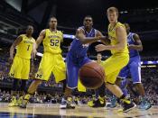Kentucky's Dakari Johnson (44) and Michigan's Spike Albrecht (2) go after a loose ball as Michigan's Glenn Robinson III (1) and Jordan Morgan (52) watch during the first half of an NCAA Midwest Regional final college basketball tournament game Sunday, March 30, 2014, in Indianapolis. (AP Photo/Michael Conroy)