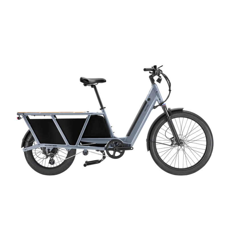 <p>Velotric</p>Velotric Packer<ul><li>Battery Power: 691 Wh</li><li>Motor Power: 750W</li><li>Range: Up to 52 miles</li><li>Payload: 440 lbs</li><li>Class 2 (up to 20 mph with throttle)</li></ul><p>The Velotric Packer stands out as a stellar value cargo bike, delivering premium features without the hefty price tag. With a potent 750W motor and a substantial 691Wh battery, it effortlessly cruises through urban terrains, offering a commendable range of up to 52 miles. </p><p>Boasting an adjustable stem for customizable comfort, a waterproof storage bag for all-weather versatility, and an impressive 176lbs rear rack capacity, the Packer is a a cargo bike for the blue-collar type. With a payload capacity of 440 lbs, it excels in carrying substantial loads with ease. </p><p>As a Class 2 e-bike, reaching speeds up to 20mph with throttle assistance, the Velotric Packer rivals its pricier counterparts, making it a top choice for those seeking high-performance and value in one robust package.</p>