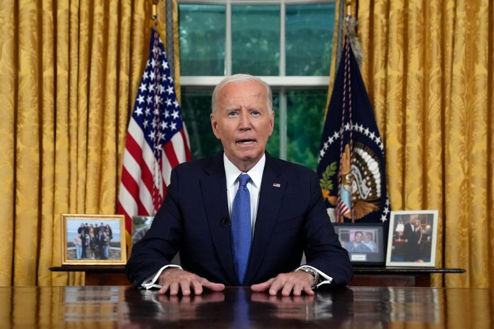 Biden family photos sat behind President Joe Biden as he delivered his address to the nation on Wednesday (AP)