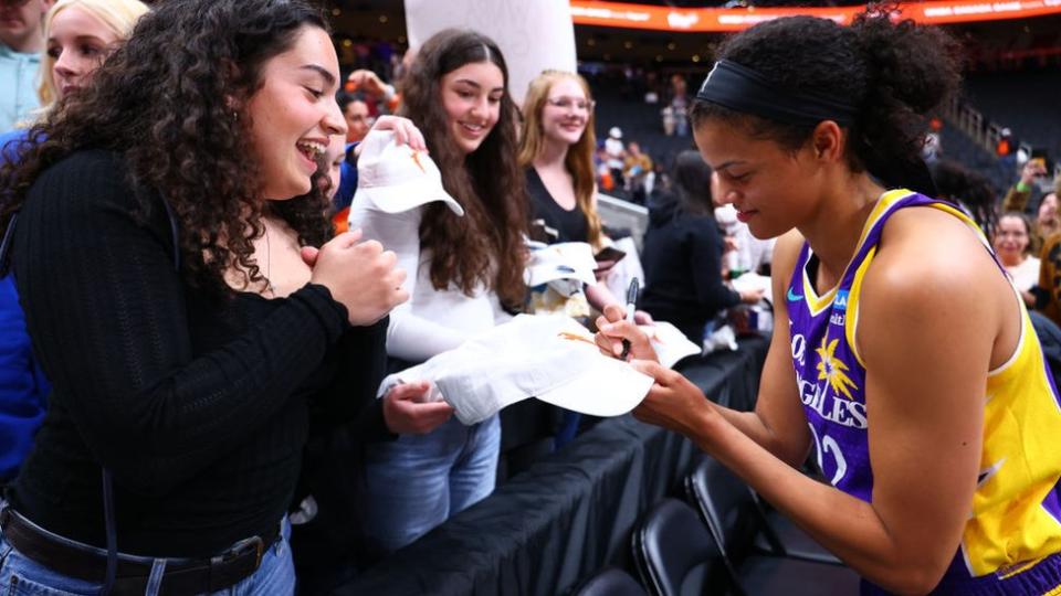 Rae Burrell #12 of the Los Angeles Sparks signs fan gear after the game on May 4, 2024 at Rodgers Place in Edmonton, Canada. NOTE TO USER: User expressly acknowledges and agrees that, by downloading and/or using this Photograph, user is consenting to the terms and conditions of the Getty Images License Agreement.