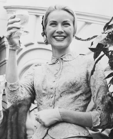<p>Bettmann</p> Princess Grace Toasts Wedding Guests at the garden party that followed her civil wedding to Prince Rainier on April 20, 1956.