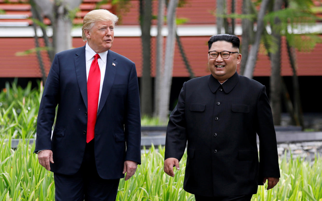 President Trump and North Korean leader Kim Jong Un walk after lunch at the Capella Hotel on Sentosa island in Singapore on Tuesday. (Photo: Jonathan Ernst/Reuters)