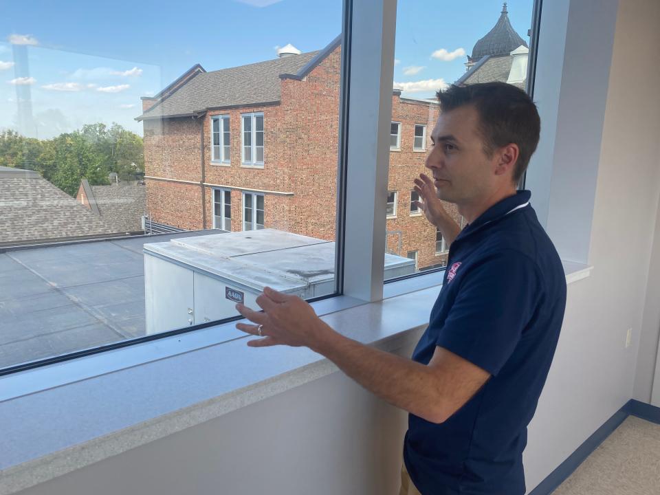 Jefferson Middle School Principal Jacob Adams on Thursday admires the view from the new third floor addition at the school. One can see every phase of the building that opened in 1900 from there, he said.