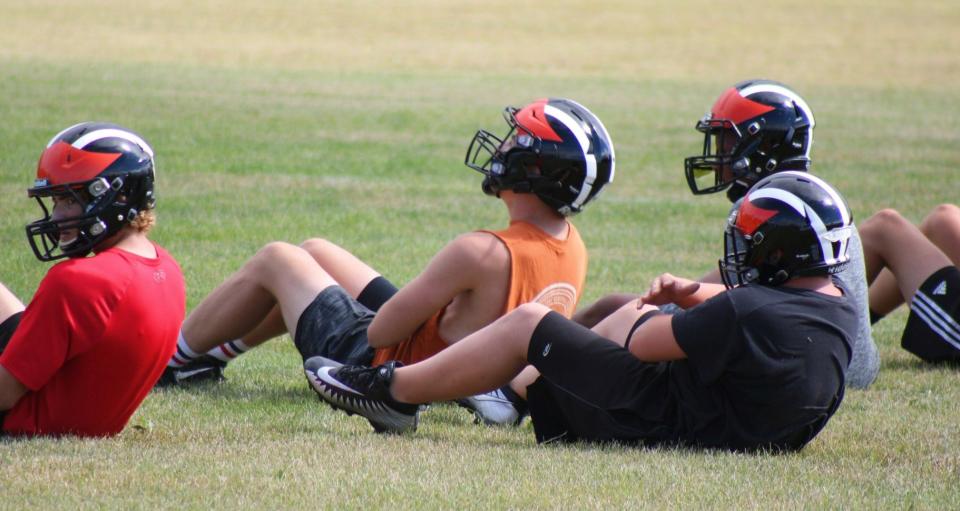 Cheboygan football players do sit-ups during their first day of practice on Monday afternoon. Conditioning has been a huge point of emphasis for the Chiefs in their first week of practice.