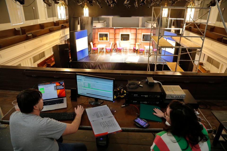 Tim Helley, sound designer, and Eva Watts-Pine, light and sound technician, prepare for the opening of Murder on the Orient Express the first show by Your Theater at the new Steeple Playhouse inside the former First Baptist Church on William Street in New Bedford.