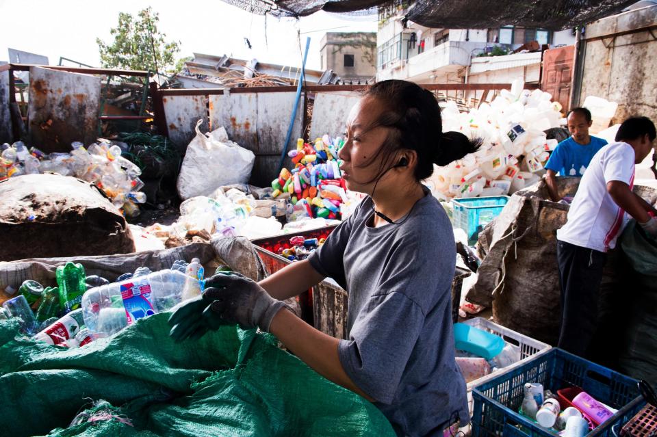 An informal recycler in Shanghai sorting through bags of plastic waste. (Photo: Grainne Quinlan for HuffPost)