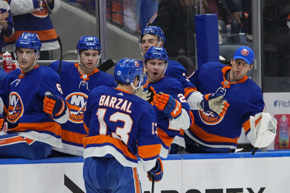 New York Islanders' Mathew Barzal (13) celebrates with teammates after scoring a goal during the second period of an NHL hockey game against the Arizona Coyotes Tuesday, Oct. 17, 2023, in Elmont, N.Y. (AP Photo/Frank Franklin II)