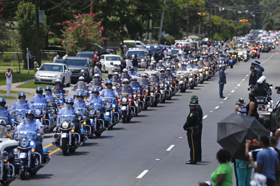 FILE - In this July 25, 2016 file photo, the funeral procession for slain Baton Rouge police Corporal Montrell Jackson leaves the Living Faith Christian Center in Baton Rouge, La. Jackson, slain by a gunman who authorities said targeted law enforcement. The number of police killed in the line of duty rose sharply in 2016, driven by shootings of police around the country, most notably ambushes in Dallas and Baton Rouge, Louisiana. From Jan. 1 through Wednesday, 135 officers lost their lives. Some died in traffic accidents, but nearly half were shot to death. (AP Photo/Gerald Herbert, File)