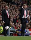Manchester United's manager David Moyes (R) reacts as Liverpool's manager Brendan Rodgers watches during their English Premier League soccer match at Anfield, Liverpool, northern England September 1, 2013. REUTERS/Phil Noble