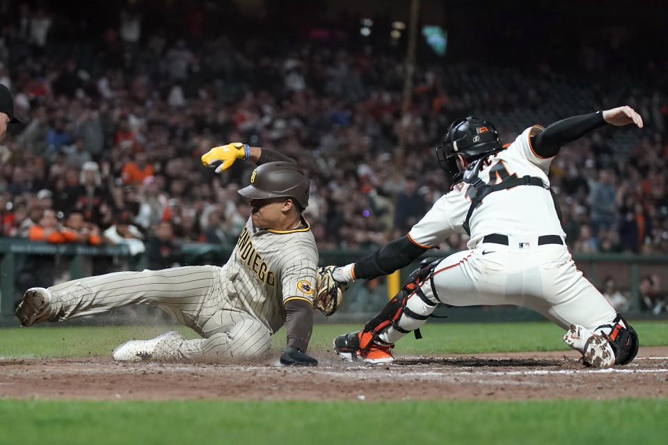 San Diego Padres' Juan Soto, left, is tagged out at home by San Francisco Giants catcher Patrick Bailey during the ninth inning of a baseball game in San Francisco, Monday, Sept. 25, 2023. (AP Photo/Jeff Chiu)
