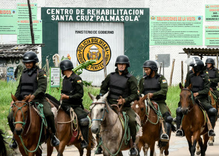 Policemen ride on horses at the entrance of Palmasola prison after a violent episode inside the prison in Santa Cruz, Bolivia, March 14, 2018. REUTERS/Rodrigo Urzagasti