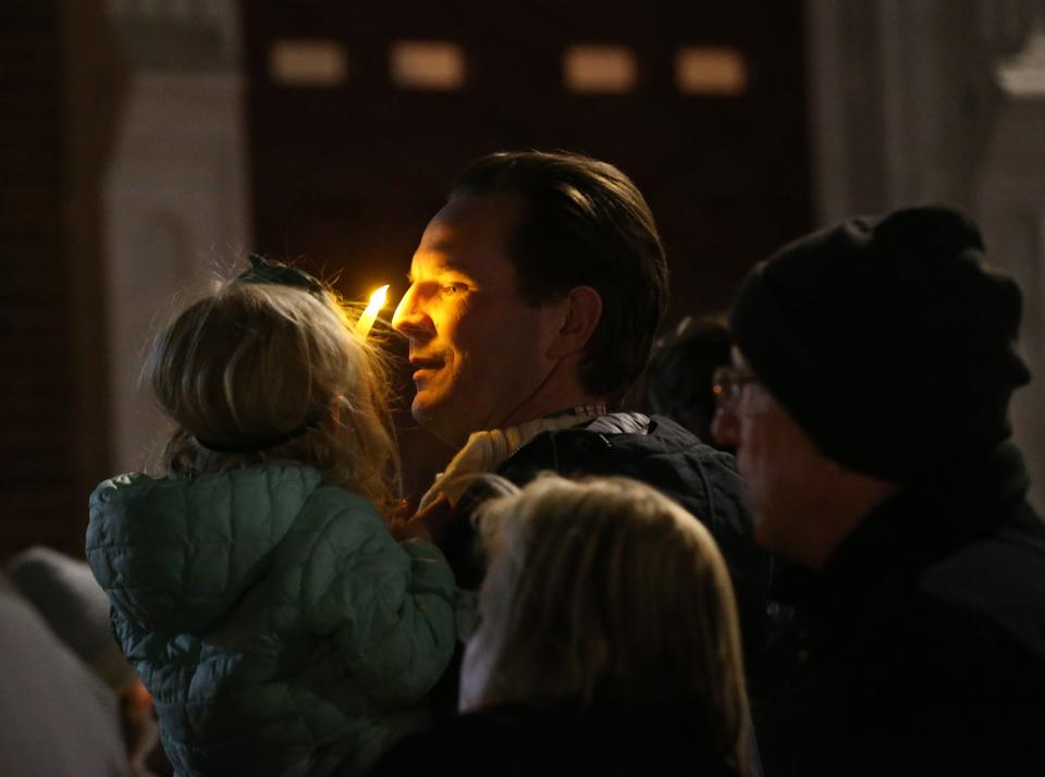 Portsmouth Mayor Deaglan McEachern attends the Homeless Persons' Memorial Day vigil with one of his daughters in downtown Portsmouth Thursday, Dec. 21, 2023.