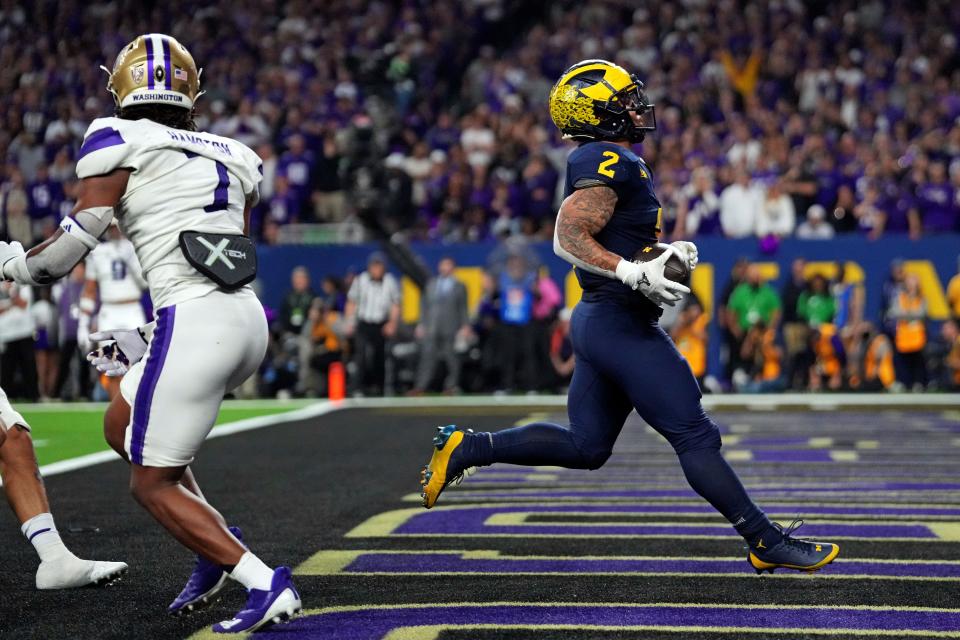 Michigan running back Blake Corum runs for a touchdown in the fourth quarter. The Wolverines' ground game produced 303 yards, the second-best rushing performance ever in a national championship game, and two 100-yard rushers. "When a play needs to be made, we'll make it because we've got a lot of playmakers," Corum said.