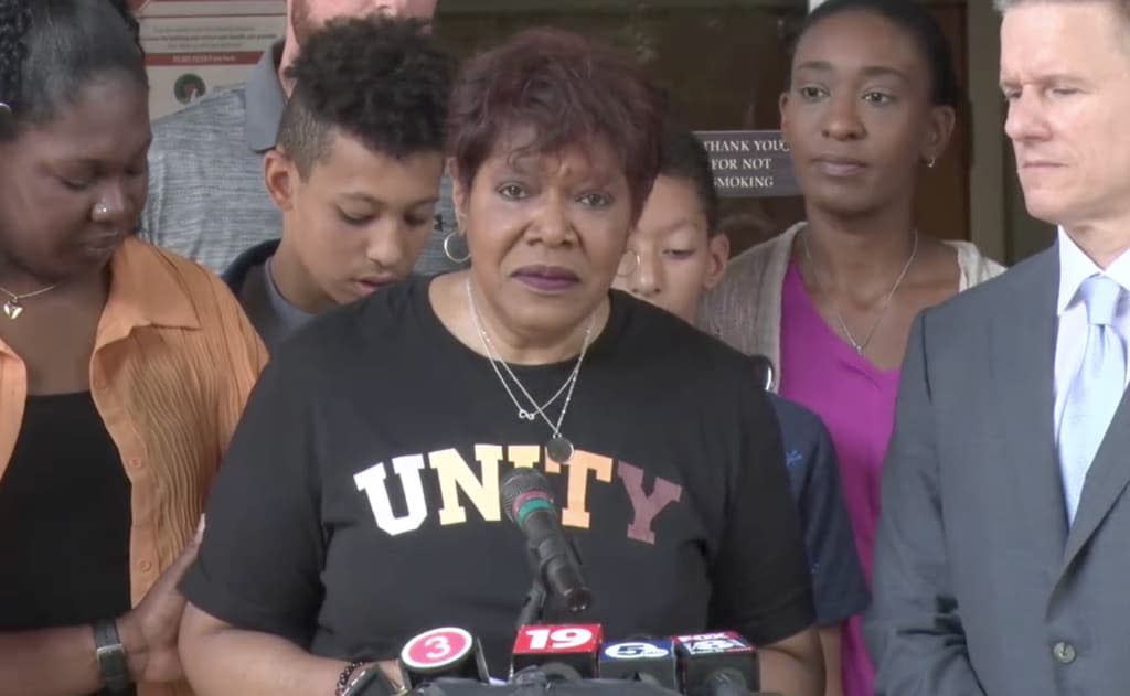 Pam Walker, center, addresses the public for the first since Akron, Ohio, police killed her son, Jayland, by shooting him 46 times after a foot chase. Family lawyer Bobby DiCello, right, has requested the U.S. Attorney’s Office to investigate Walker’s death.