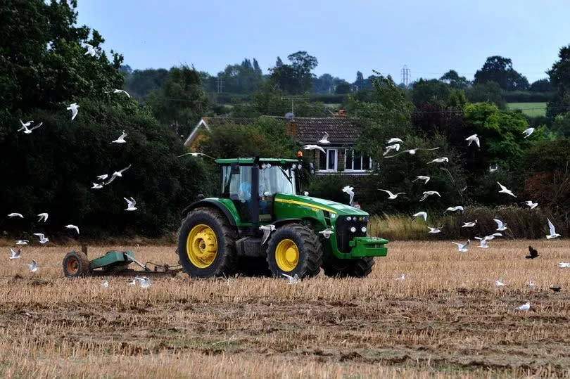 A tractor as it ploughs a field