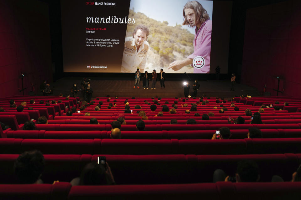 French director Quentin Dupieux, and cast members Adele Exarchopoulos, David Marsais, and Gregoire Ludig, from left to right, attend the early first cinema screening and one year delay premiere of 'Mandibules' in Paris, Wednesday, May, 19, 2021. Cinemas, as café and restaurant terraces, museums, and theaters are reopening their doors after a shutdown of more than six months in the first stage of a government strategy to incrementally lift restrictions to stave off COVID-19, and give the French back some of their signature "joie de vivre." (AP Photo/Francois Mori)