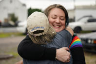 Alisha Hoffman-Mirilovich, right, and Claudia Glennan embrace at the Edwardsville Pierogi Festival in Edwardsville, Pa., Friday, June 11, 2021. (AP Photo/Matt Rourke)