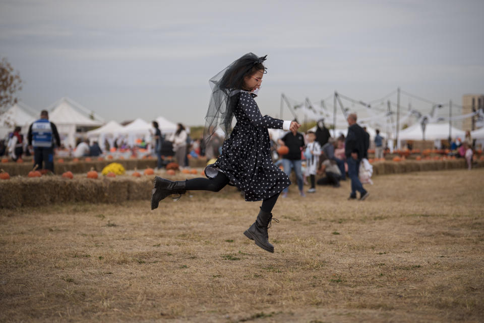 A girl plays at the West Side Hallo Fest, a Halloween festival in Bucharest, Romania, Friday, Oct. 27, 2023. Tens of thousands streamed last weekend to Bucharest's Angels' Island peninsula for what was the biggest Halloween festival in the Eastern European nation since the fall of Communism. (AP Photo/Vadim Ghirda)