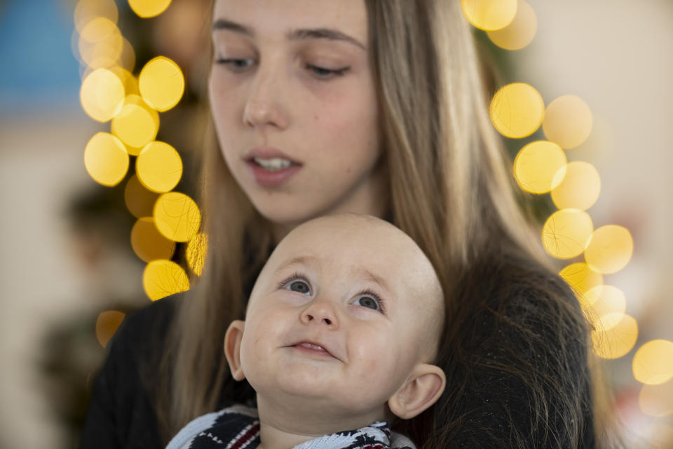 Vlada Yushchenko, a 19-year-old Ukrainian refugee, holds her son Daniel, during an interview with The Associated Press in Brasov, Romania, Thursday, Feb. 2, 2023. Yushchenko was still in her teens and nearly three months pregnant when she hugged her husband at the border, turned away and walked into Moldova. Now she’s in Romania, one of the millions of Ukrainians forced to flee Russia’s invasion of their country. Her baby, Daniel, was born there eight months ago and still hasn’t met his father Yaroslav, who is 21 and, like most men of fighting age, prohibited from leaving Ukraine. (AP Photo/Vadim Ghirda)