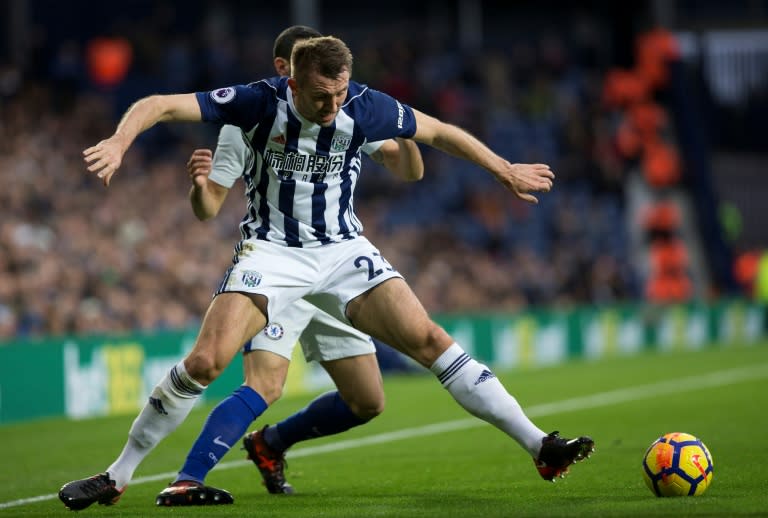 Chelsea's Davide Zappacosta (rear) fights for the ball with West Bromwich Albion's Gareth McAuley during their English Premier League match, at The Hawthorns stadium in West Bromwich, on November 18, 2017