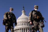 Members of the National Guard walk past the Dome of the Capitol Building on Capitol Hill in Washington, Thursday, Jan. 14, 2021. (AP Photo/Andrew Harnik)