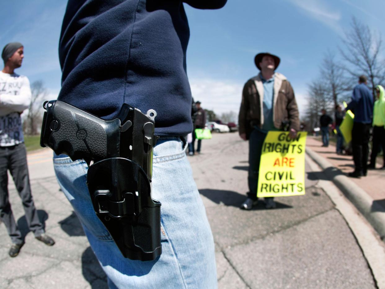 A supporter of Michigan's Open Carry law attends a rally and march April 27, 2014 in Romulus, Michigan: Photo by Bill Pugliano/Getty Images