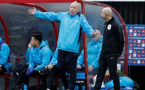 Martin Tyler talks to the fourth official - Credit: Reuters