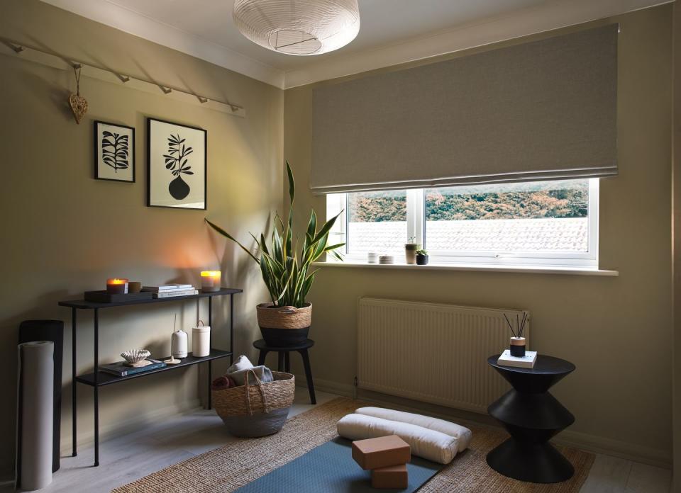 yoga room with a bed and a table with a plant on it