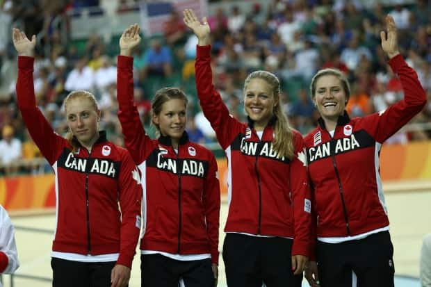 Simmerling, far right, after winning bronze as a member of Canada's pursuit cycling team at the Rio Olympics.